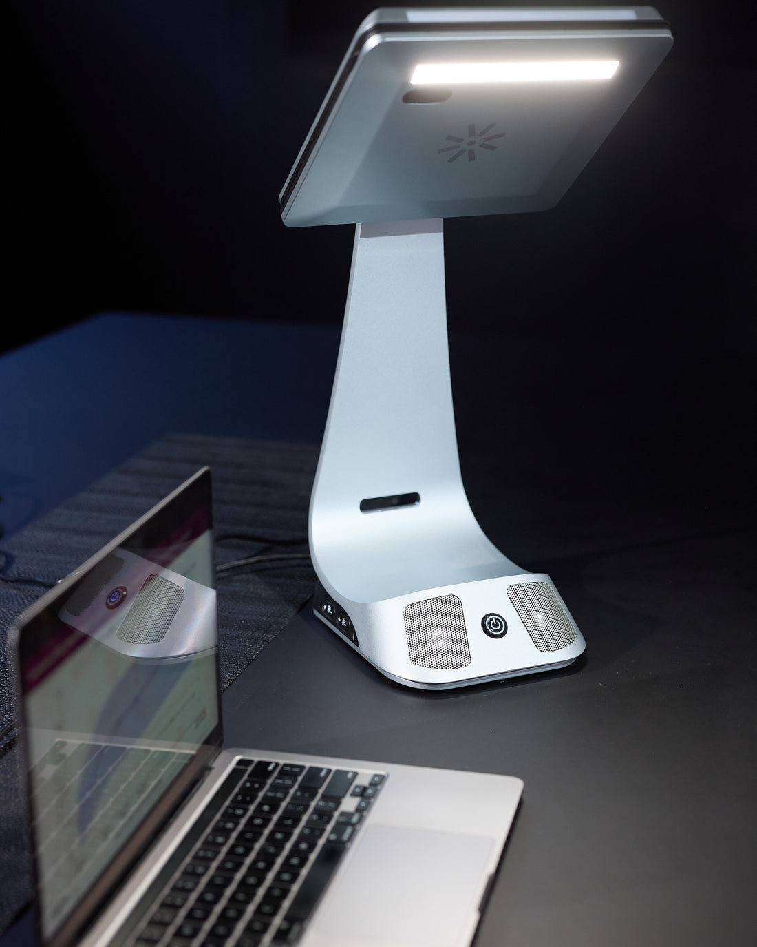 iVi with integrated lighting on over a laptop in a dark room, showing the top light in use.