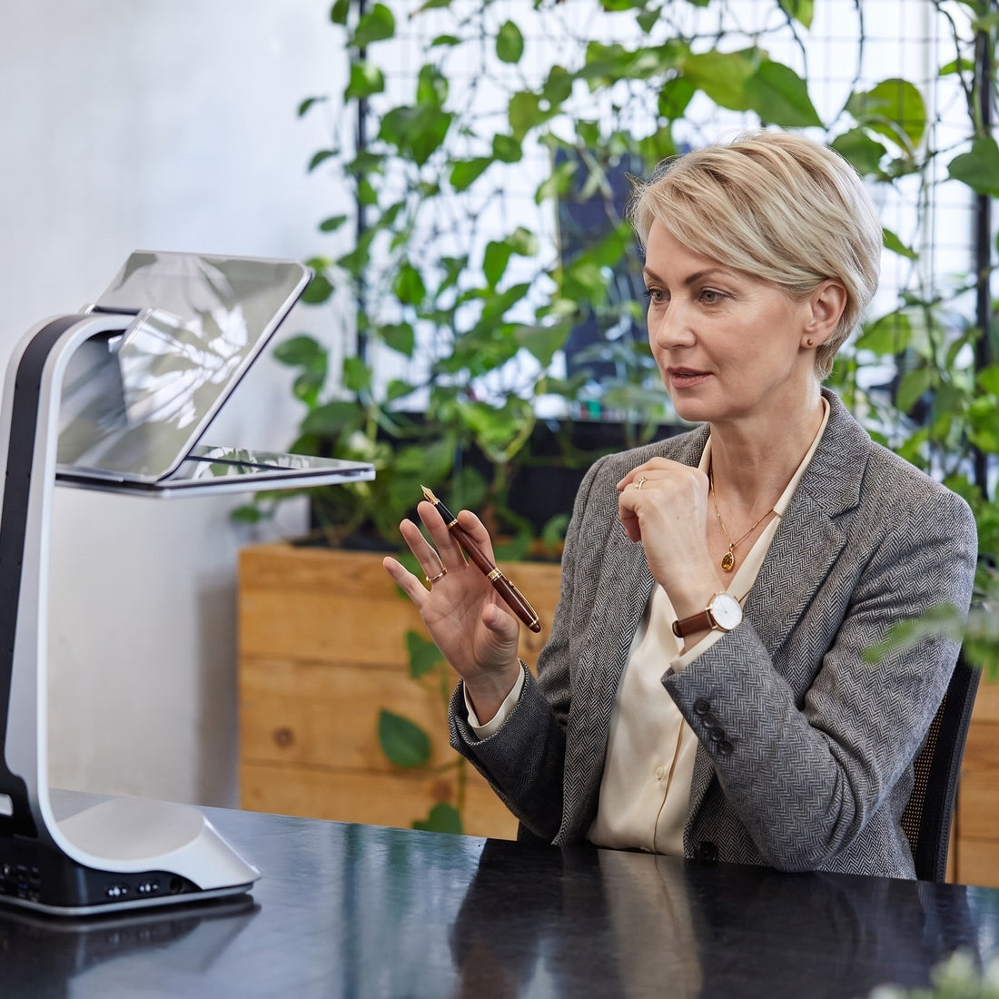 iVi on a clean premium desk setup beside a laptop, showing the product in a modern workspace.